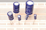 Through-Hole Capacitor for Physics Experiments